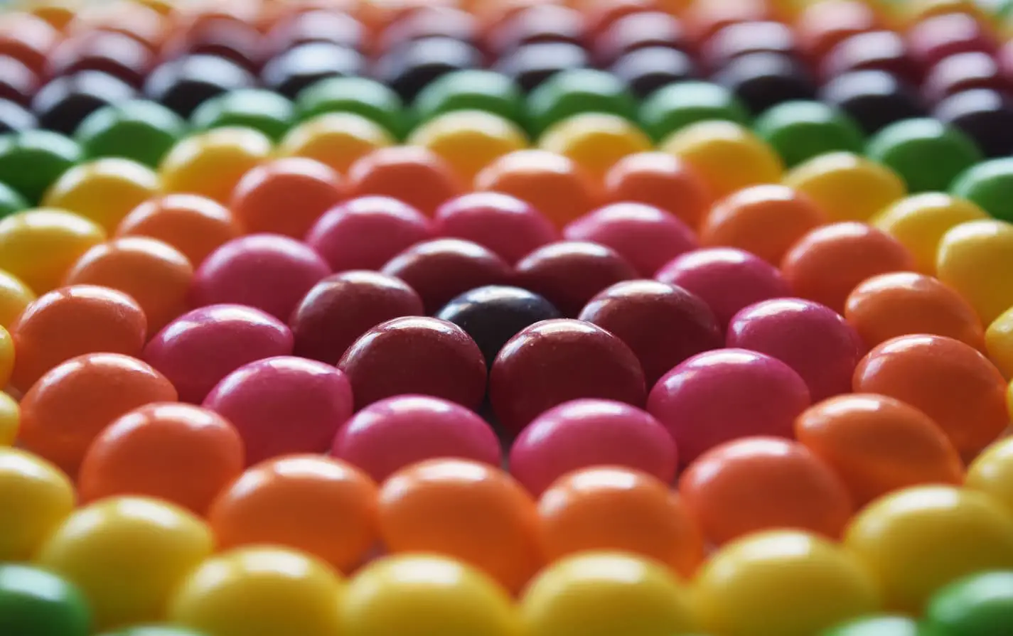 an image of skittles arranged in a rainbow