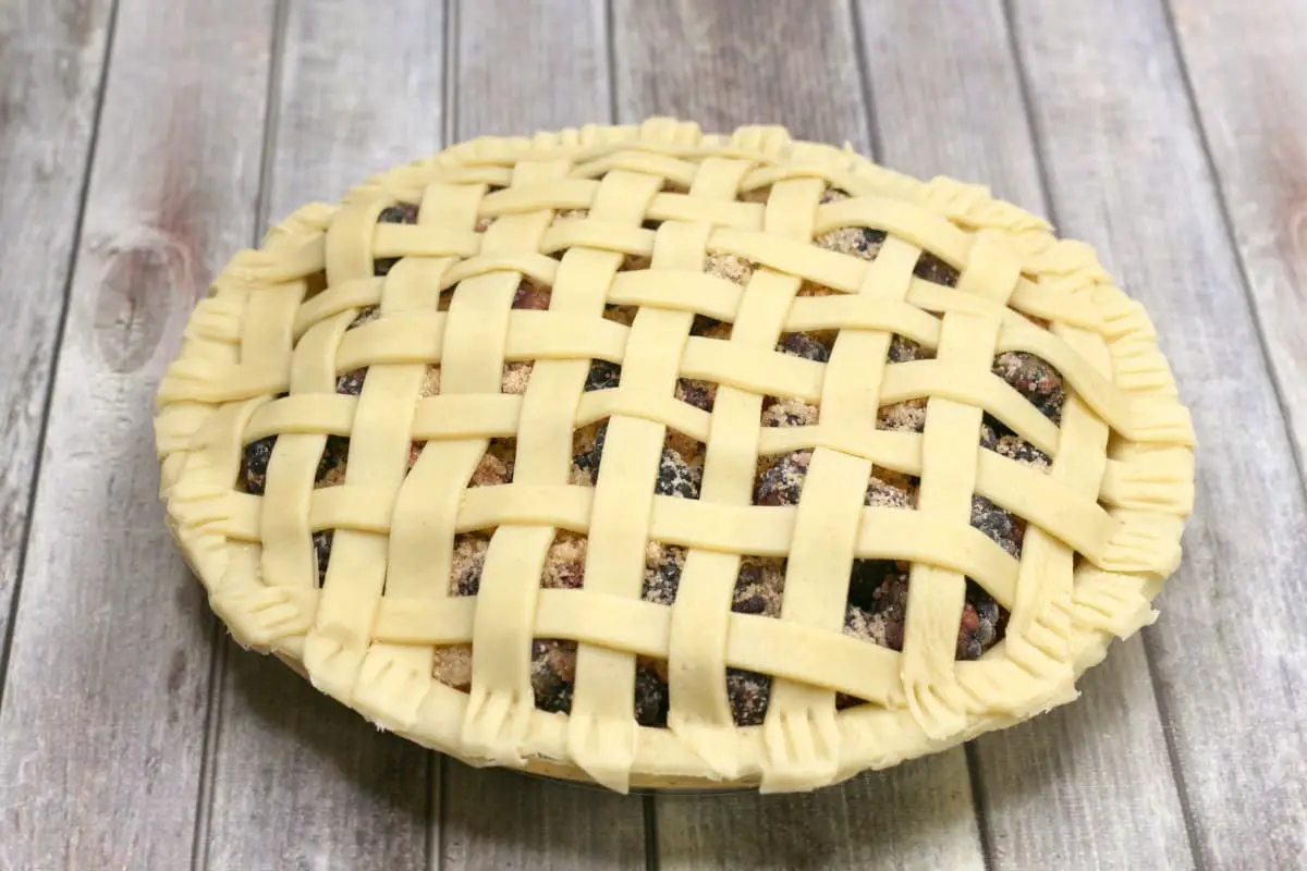image of a blackberry pie that needs to be baked