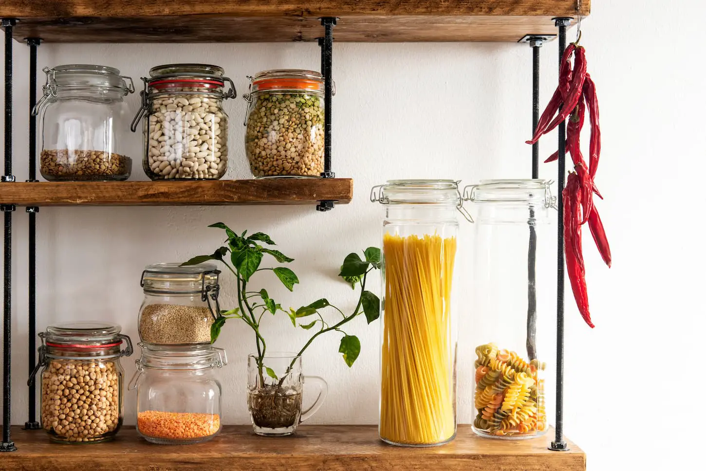 An image of an assortment of dried food in jars on a shelve.
