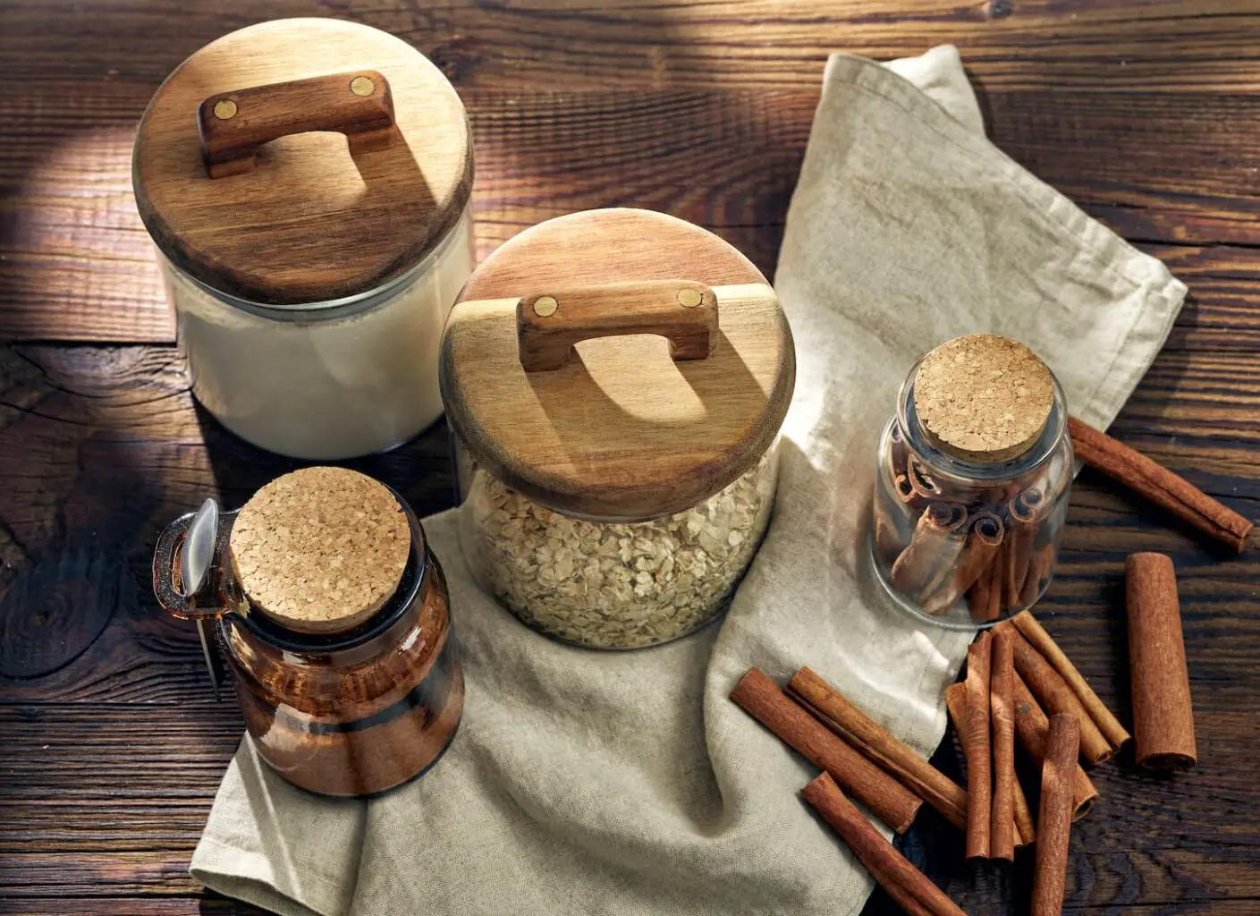 An image of product storage jars on a brown wooden kitchen table.