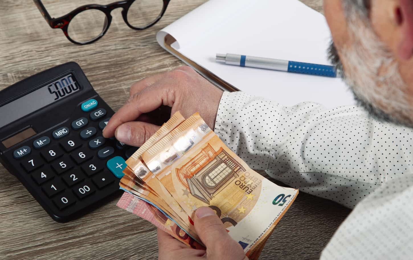 The Advantages and Disadvantages of Home Freeze-Drying 2 An image of a man calculating monthly costs and expenses.