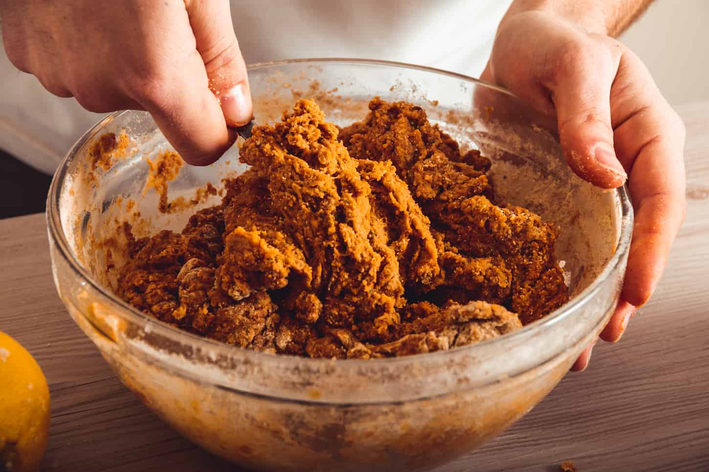 An image of a man's hands making homemade seitan in the kitchen.