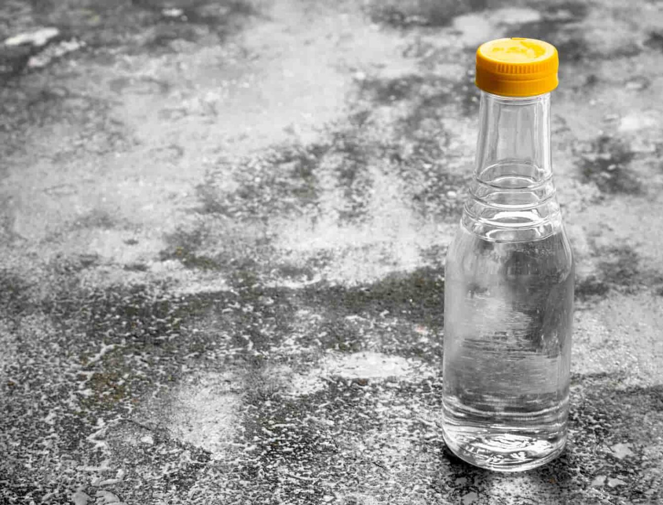 An image of a bottle of vinegar on a rustic background.